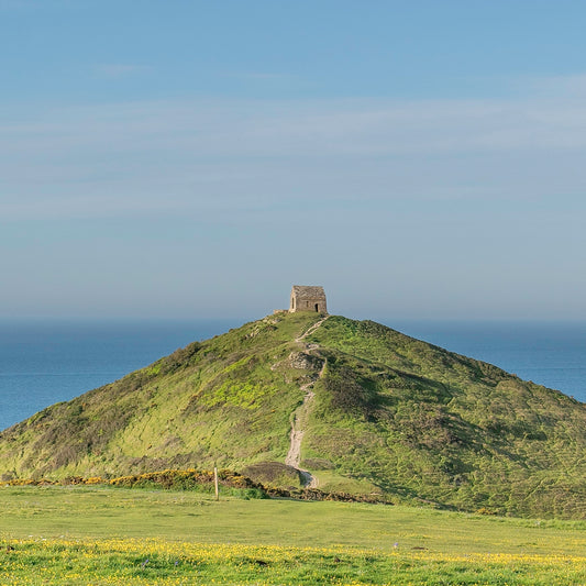 The chapel at Rame Head on an early summer morning looking out over a calm sea
