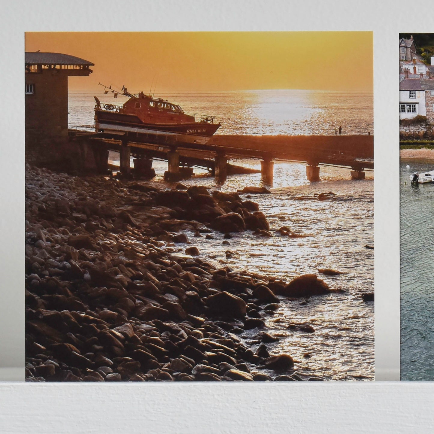 Cornish greetings card showing Sennen lifeboat launching into the sea at sunset