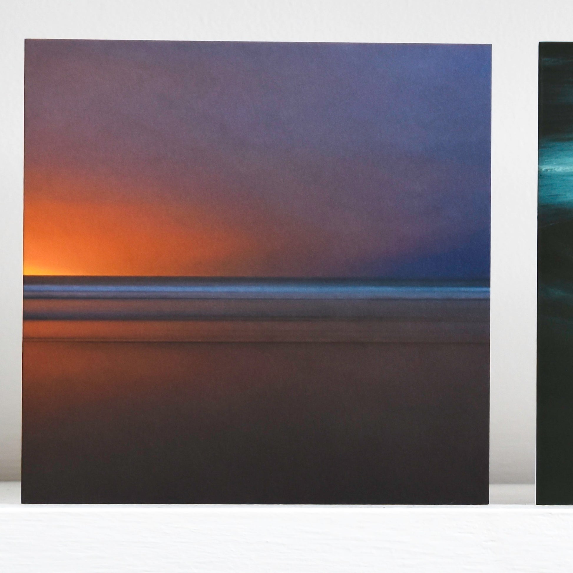 Art card showing an sunset over waves, blending from amber to indigo