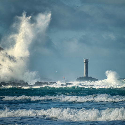 An Evocative Cornwall greetings card showing the Longships Lighthouse off Land's End dwarfed by a towering wave rebounding off the cliffs at Sennen