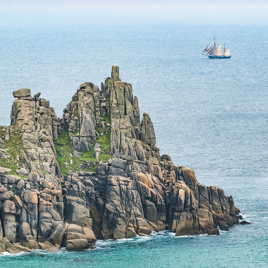 A schooner - or is it a pirate ship?! - passes Logan Rock, near Land's End