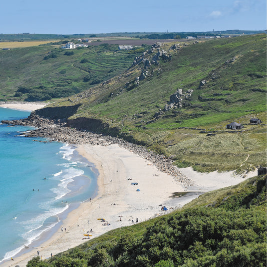 An Evocative Cornwall greetings card image looking down at the white sands and turquoise water of Sennen Beach and the surrounding granite crags of the cliffs, terraced hillside and dunes.