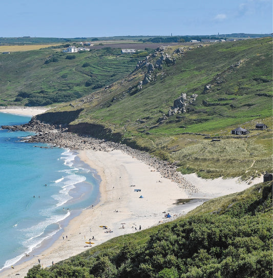 An Evocative Cornwall greetings card image looking down at the white sands and turquoise water of Sennen Beach and the surrounding granite crags of the cliffs, terraced hillside and dunes.