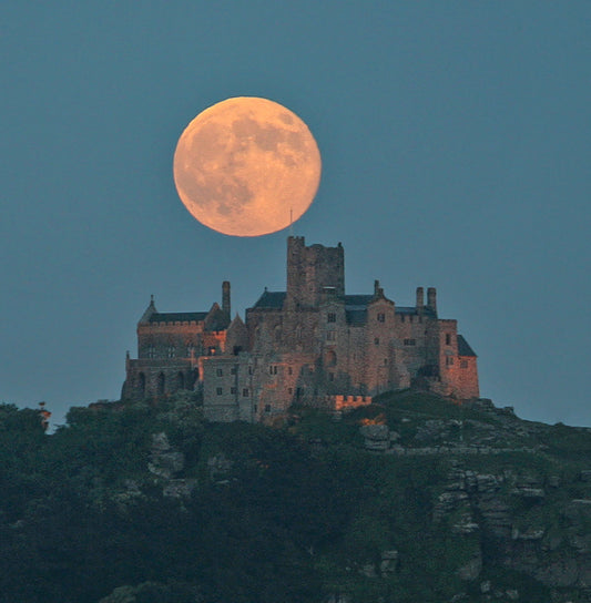 Cornish greetings card image of an orange super moon rising above the castle on St Michael's Mount