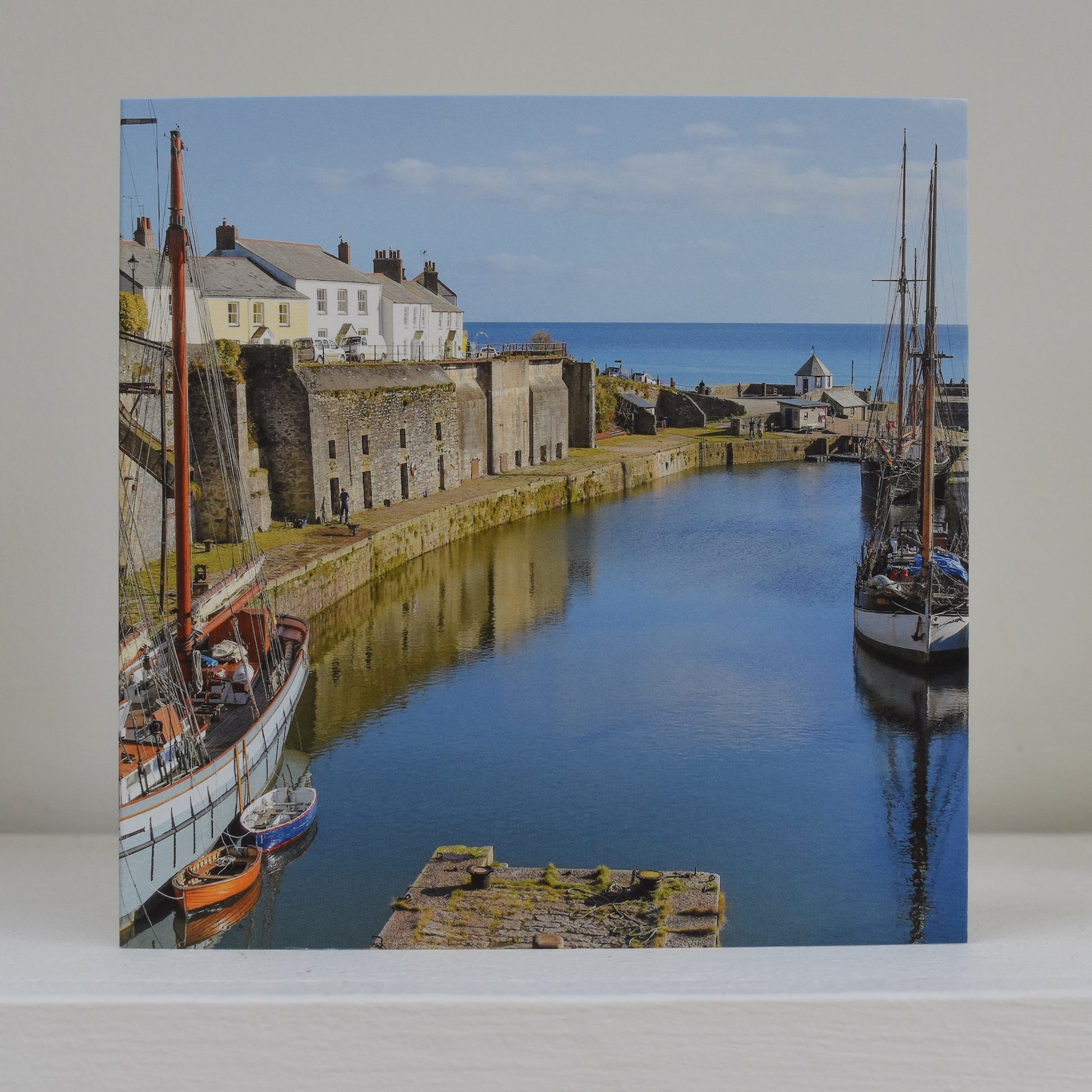 Greeting card on shelf, showing an image of Charlestown Harbour on a beautiful sunny day with tall ships at anchor
