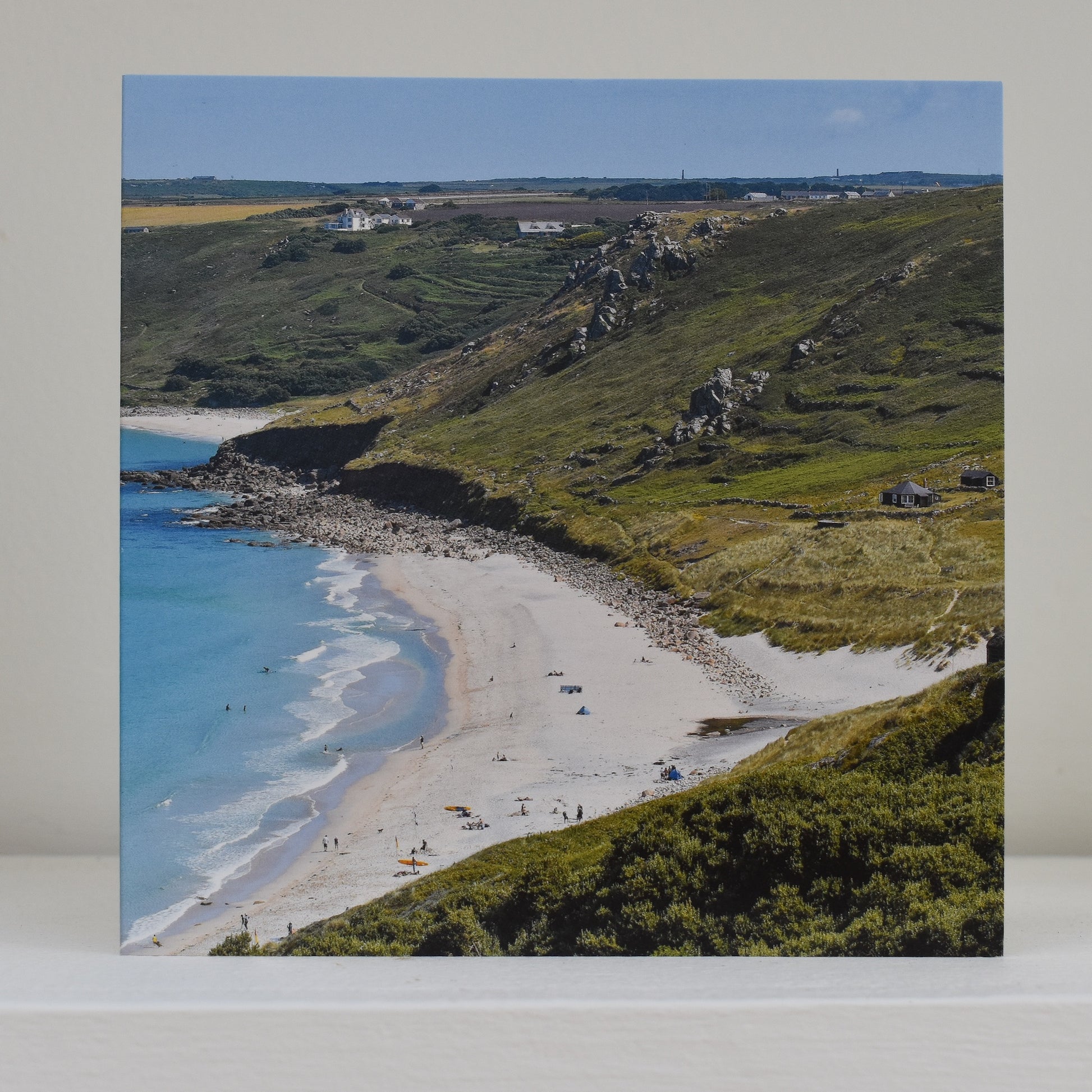 Image of greeting card on shelf, showing Sennen Beach and the surrounding landscape