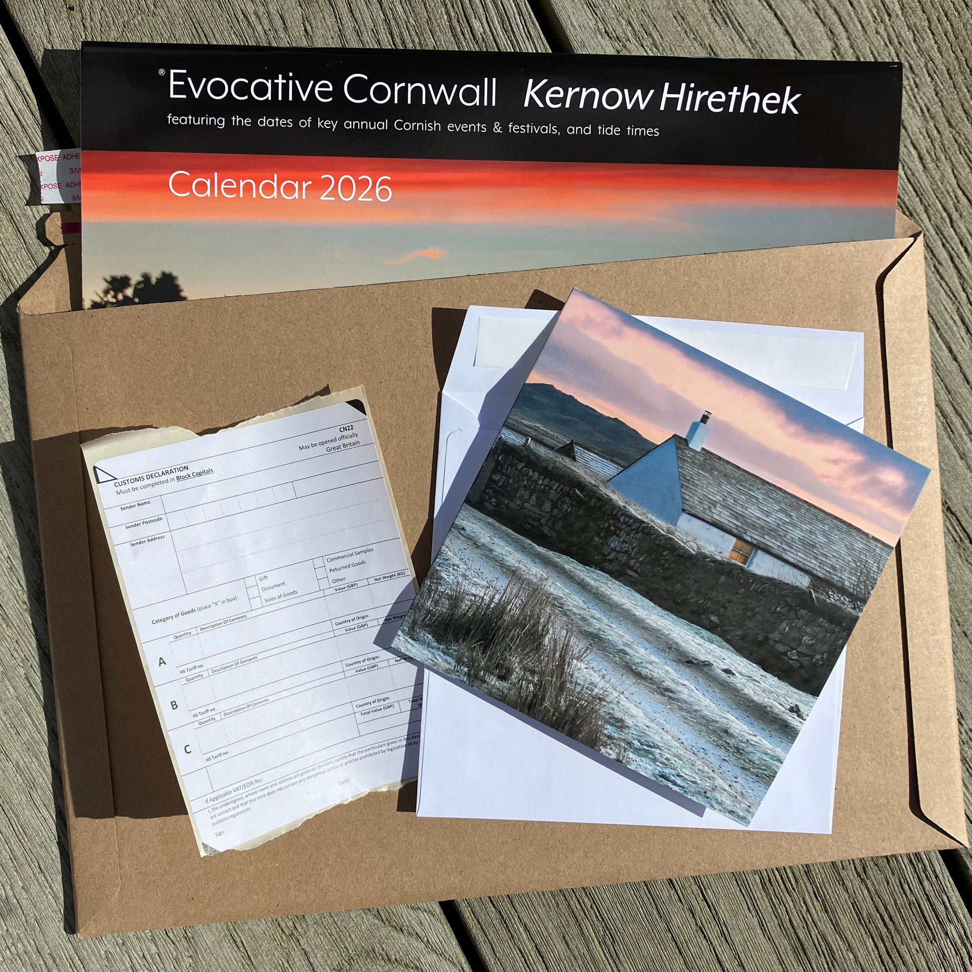 The components of Send Abroad calendar offer - calendar in cardboard envelope, Christmas card in envelope and customs form which is completed for you