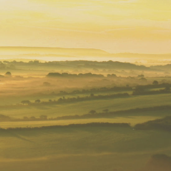 Video animation of a greeting card image showing the sunrise across farmland at Helman Tor near Bodmin