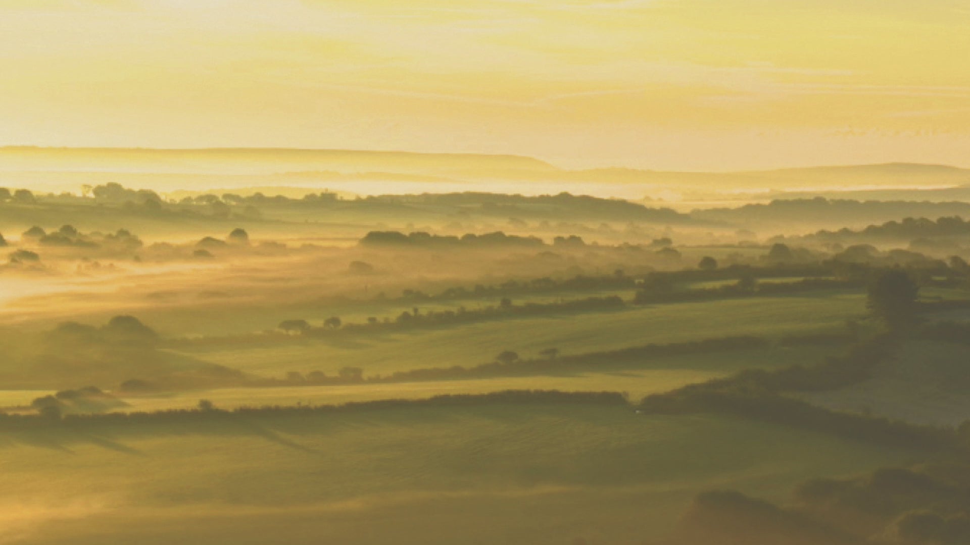 Video animation of a greeting card image showing the sunrise across farmland at Helman Tor near Bodmin