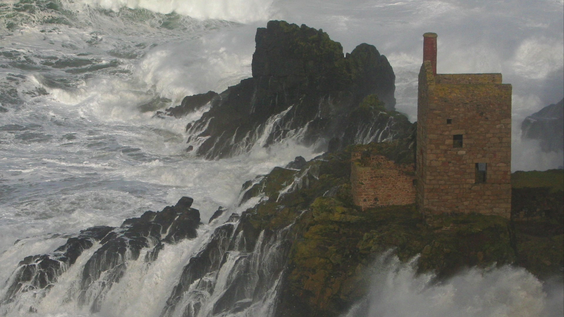 Video animation of greeting card showing The Crowns at Botallack perched on a rock with waves broiling around