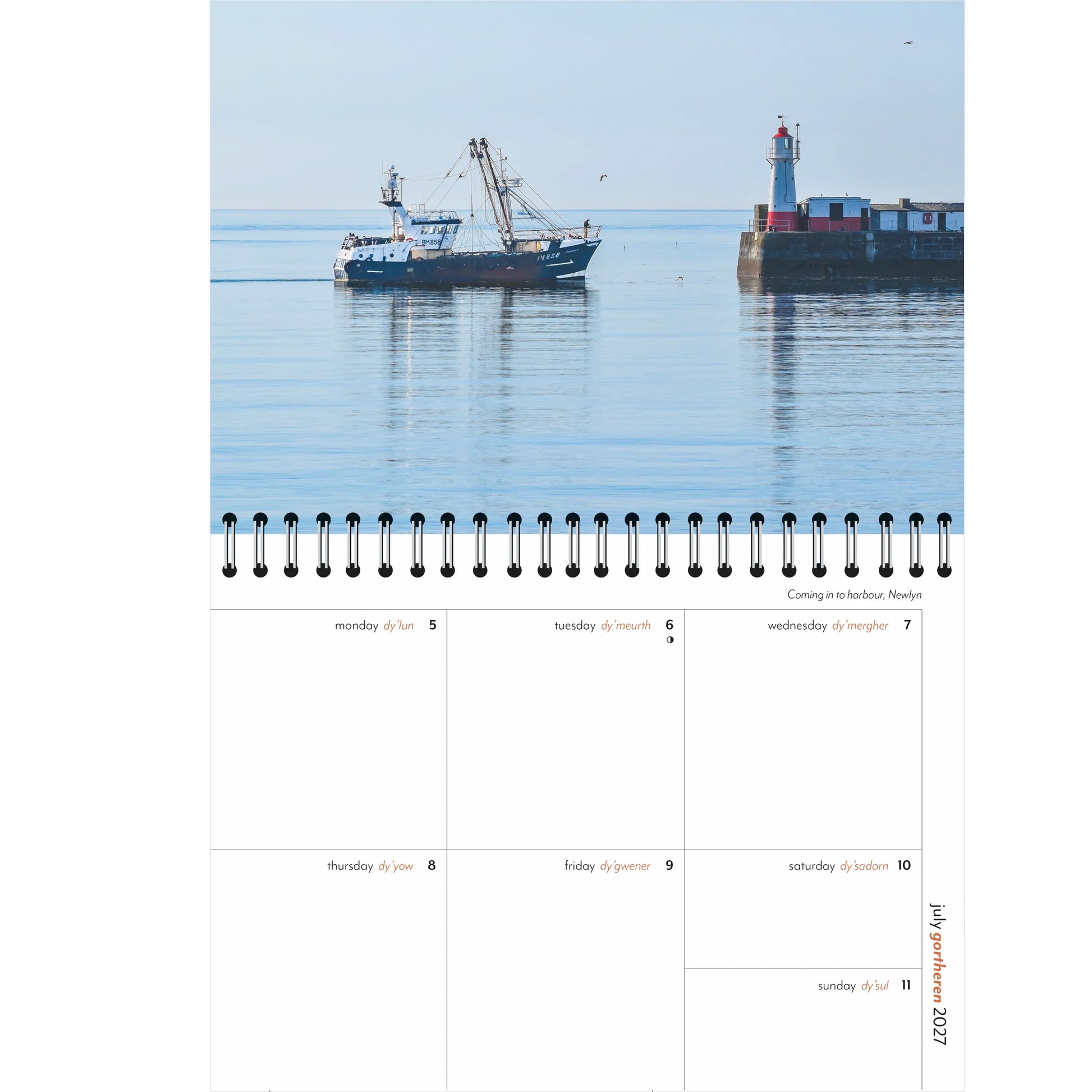A single-page spread from a spiral-bound 2027 weekly diary, featuring a photograph of a fishing boat coming in to Newlyn harbour on a calm water morning, with weekly planning page beneath. 